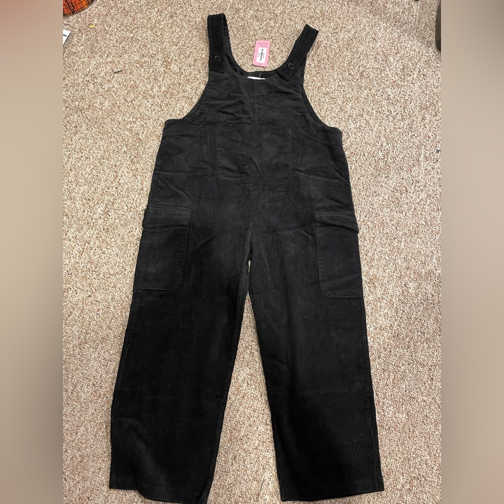 Black overalls with brown bear on the back